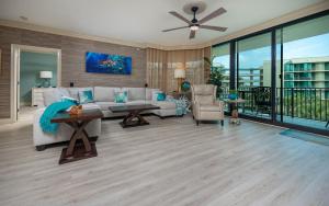 a living room with a couch and a table at Phoenix on the Bay 1307 condo in Orange Beach