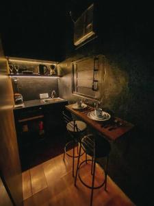a small kitchen with a table and two bar stools at Lux in Igrejinha