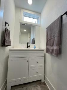 a bathroom with a white sink and a mirror at 2 Bedroom Apartment, Walk To Mayo, Free Parking in Rochester