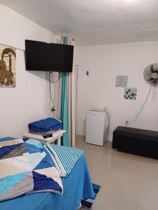 a hospital room with a bed and a flat screen tv at Habitación margarita in Bayahibe