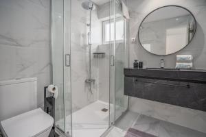 a bathroom with a shower and a toilet and a mirror at Villa 4 Alvor in Alvor +27 photos