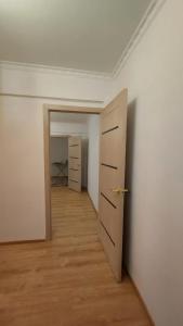an empty room with a door and a hallway at Двухкомнатная 19-7 in Atyraū