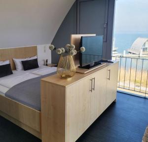 a bedroom with a bed with a vase with flowers at Appartment Seeblick 8 2 OG Grundbelegung 4 Pers in Elsterheide