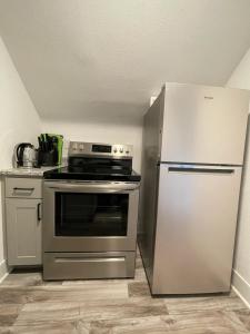 a kitchen with a stove and a refrigerator at A Restful Retreat - Walk to Mayo - Free Parking in Rochester