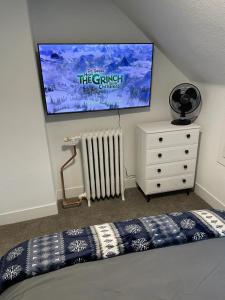 a bedroom with a bed and a tv on the wall at Heart of Downtown Free Parking Walk to Mayo in Rochester