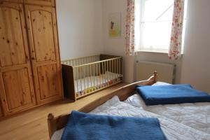a bedroom with a crib and a crib at Silva Mare, OG 2 in Kellenhusen