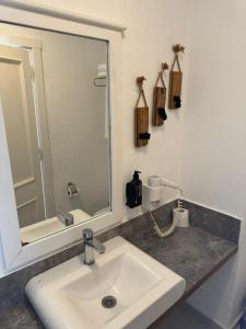 a bathroom with a sink and a mirror at Lizbonia Çeşme in Çeşme