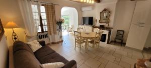 a living room with a couch and a table at Appartements de charme La Sarrazine in La Garde-Freinet
