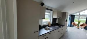 a kitchen with a sink and a counter top at Vakantiepark Bronckhorst in Hengelo