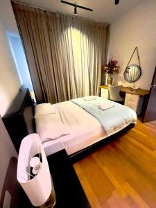 a bedroom with a bed and a desk and a window at Regalia Home Stay in Kuala Lumpur
