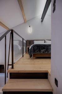 a bedroom with a bed and a wooden staircase at 1050 Mountain Living in Pávliani