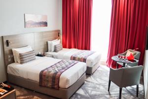 Postel nebo postele na pokoji v ubytování FORTUNE ATRIUM HOTEL