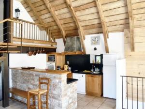 a kitchen with white appliances and wooden ceilings at Maison de 4 chambres avec jardin amenage a Castelnau de Mandailles in Castelnau-de-Mandailles