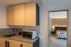 a kitchen with a sink and a microwave on a counter at Hotel Boston in Stresa
