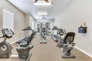 a gym with treadmills and exercise machines at Stylish Home with Pool Access, 10 Mi to Vegas Strip! in Las Vegas