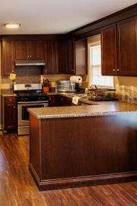 a kitchen with wooden cabinets and a stove top oven at In the heart of the QC! in Charlotte