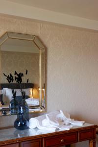 a dressing table with a mirror and towels on it at Hotel Schiff am See in Murten