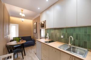 a kitchen with a sink and a table at Piernikowy i Cynamonowy Toruń z parkingiem in Toruń