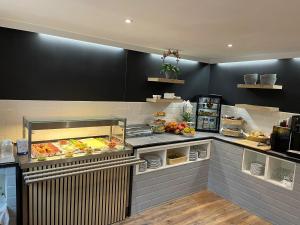 a kitchen with a counter with food on it at Hotel Birnbaum in Ansbach