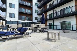 a patio with chairs and tables in a building at HUGE New Apartment Next to Mayo, Free Parking in Rochester