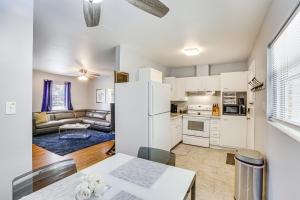 a kitchen and living room with a white refrigerator at Tallahassee Home with Yard Less Than 2 Mi to FSU Campus in Tallahassee