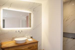 a bathroom with a sink and a mirror at le 47, une pause à la campagne in Duisans