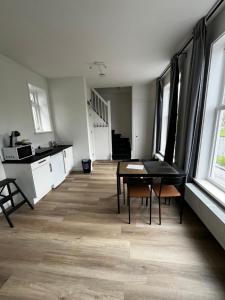 a kitchen and dining room with a table and chairs at Stays by ADM in Leiden