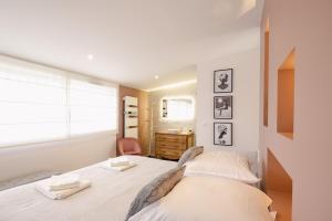a bedroom with two beds and a window at le 47, une pause à la campagne in Duisans +60 photos