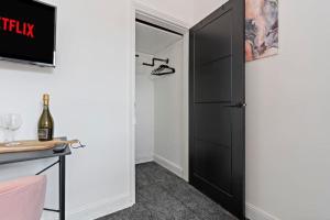 a room with a black closet with a black door at Masterson House By RMR Accommodations - NEW - Sleeps 9 - Modern - Parking - Central in Stoke on Trent