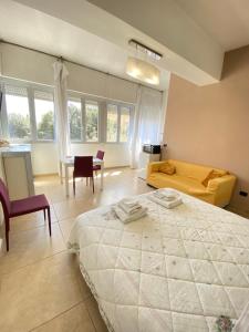 a bedroom with a large bed and a table and chairs at Abruzzi 81 in Lecce