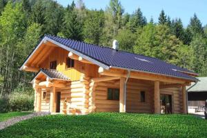 a log cabin with a solar roof on it at Seehaus Alm in Ruhpolding