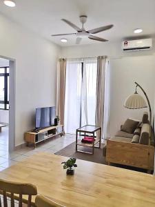 a living room with a couch and a table at MUJI Cosy Level 25th Room Amber Residence @ Quayside Mall Rimbayu Near to Masha Oasis Tenby KLIA Kota Kemuning in Teluk Panglima Garang