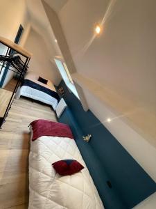 a bedroom with a bed in the middle of a room at La Poserie des Monts et Vallées in Esson