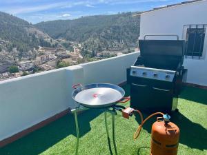 a grill and barbecue on a balcony with a view at Casa Teresa in Alcalá del Júcar