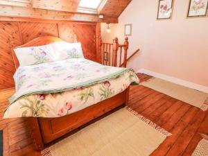 a bedroom with a bed in a room with wooden floors at Waters Edge in Bakewell