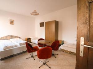a bedroom with two beds and a table and chairs at Müller's 3 in Siófok +28 photos