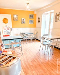 a room with tables and chairs in a building at Mon P'tit Hôtel in Le Grau-dʼAgde