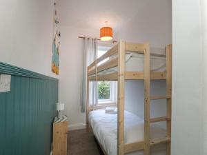 a bedroom with a bunk bed and a window at 14 Birtley Avenue in North Shields