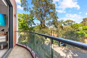 a balcony with a view of a tree at Nice and quiet studio Roseville in Sydney