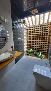 uma casa de banho com um lavatório, um WC e uma janela. em Casa Mari - ilha de Algodoal em Maracanã