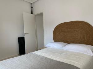 a bedroom with a bed with a large headboard at Reconquista Toledo in Toledo