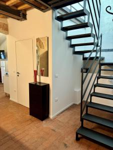 a black spiral staircase in a room with a floor at Casa Viaggi in Castel Guelfo di Bologna