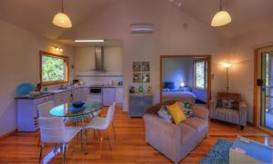 a kitchen and living room with a couch and a table at Roosters Rest in Port Sorell