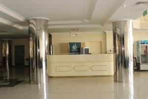 a lobby with a counter in the middle of a building at فندق سرر المحمديه الرياض in Riyadh
