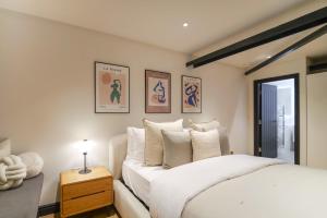 a bedroom with a white bed and a window at Omnia by The Heim Residences in Manchester