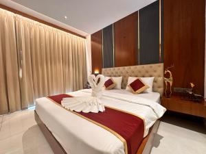 a bedroom with a large bed with a wedding dress on it at Holiday Valley Hotels And Resorts in Denkanikottai