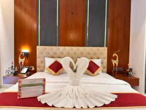 a bed with a white dress with a heart on it at Holiday Valley Hotels And Resorts in Denkanikottai