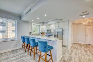 a kitchen with blue chairs at a counter at Foxy Palmer Lost Key 205 in Perdido Key