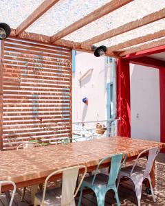a wooden table and chairs on a patio at Mon P'tit Hôtel in Le Grau-dʼAgde