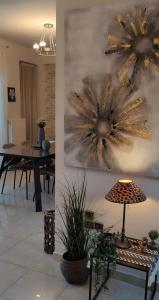 a living room with a table and a painting on the wall at MariZot Apartment in Alexandroupoli